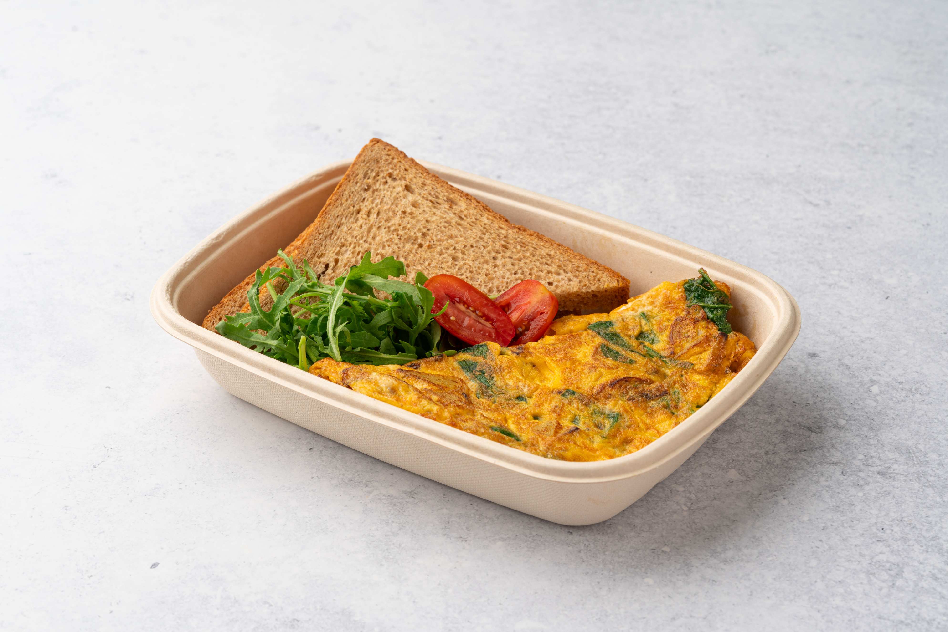 Omelette With Potatoes Spinach And Feta Cheese Served With Brown Bread